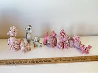 front view of all eleven poodle figurines lined up by size