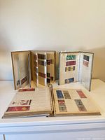 All three albums open to pages showing assorted matchbook covers