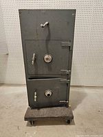 Front view showing two doors, dials, handles, hinges, dolly