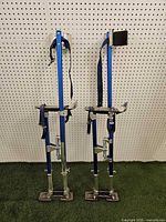 Full view of both stilts standing upright