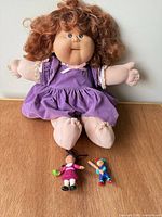 Full view of Cabbage Patch Kids doll and two PVC figures