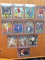 All 12 sleeved checkerboard refractor cards laid out
