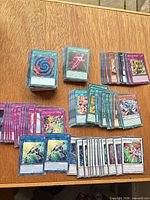 Overview of multiple stacks showing green Spell, pink Trap, blue Link, white Synchro and orange Monster cards