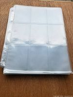 Stack of clear 9-pocket binder pages