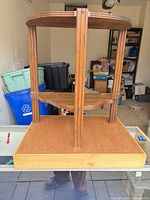 full view of two-tier corner wall shelf on table