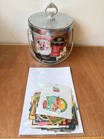 Overall view of bucket with lid and handle plus stack of labels