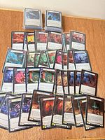 Overview of spread of Flesh and Blood foil commons plus stacked sleeved blocks