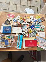 Entire spread of assorted vintage matchbooks and boxes on table