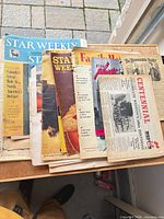 Stack of newspapers and magazines including Star Weekly, Family Herald, Hydro News, Centennial Weston