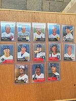All 13 Topps Chrome rookie cards displayed in two rows on wood surface