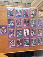 Front view of 21 sleeved purple-border cards displayed on tabletop