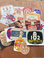 All 22 assorted beer labels spread on tabletop