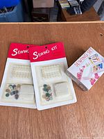 Two red carded sewing kits and boxed sewing set