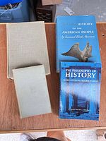 All four books laid out showing covers and bindings