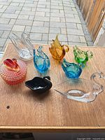 All eight glass items on tabletop