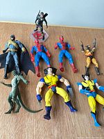 Group shot showing seven figures on wooden surface