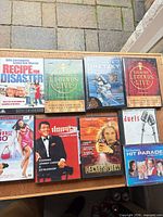 Tabletop view showing all nine DVD and CD cases front covers