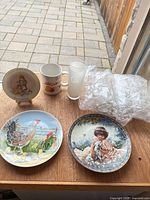 All items grouped: three plates, mug, one unwrapped tumbler plus bubble-wrapped remainder