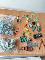 Overall lot showing loose figures, vehicles, accessories on tabletop