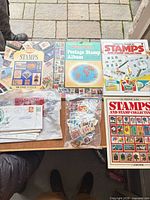 Top view of all books, loose stamps bag and first day covers