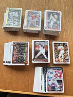 Stacks of Topps baseball cards spread on table