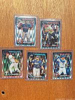 All five sleeved refractor cards laid out