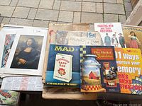 Overview of main items: MAD magazine, art print Mona Lisa, Hamlyn and other books visible