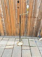 Full view of brass base, black shaft, swing arm