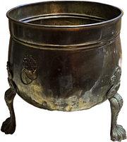 Front view showing brass planter, claw feet, lion head handle