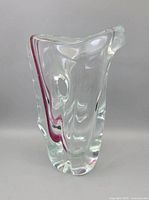 Front view of clear glass vase with purple ribbon showing overall shape