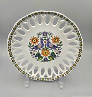 Front of Schmidt porcelain plate showing pierced rim and peacock floral design