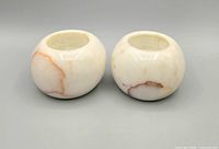 Front view of both polished stone tealight holders