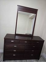 Front view of dresser with attached mirror showing drawer configuration and condition