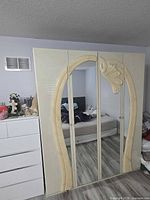 Front view of cream high-gloss four-door wardrobe with raised arch design