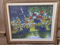 Front view of framed floral landscape painting