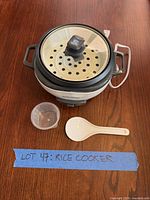 Full cooker with lid, steamer tray, measuring cup, rice paddle