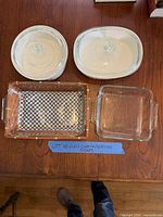 Full set laid out: two oval casseroles with lids, rectangular and square glass dishes, wicker basket