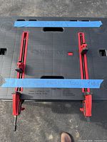 Top view of folded Husky workbench showing clamps and branded surface