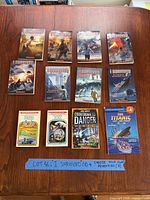 All twelve books arranged on tabletop showing fronts