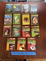 All 15 Nancy Drew paperbacks laid out on table