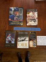 All four books displayed cover up on table