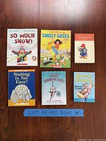 All six children’s books laid out on wooden surface
