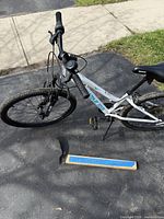 Left side view of white Nakamura 24-inch kids mountain bike on driveway