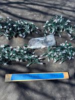 All four bundled green-wire strings of faceted white lights with spare bulb pack