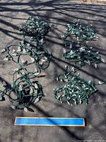 Six bundled LED light strings laid out on pavement
