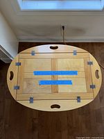 Top view of tray showing maple panels, handle cut-outs, hinges
