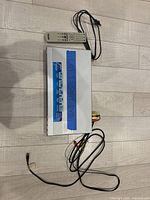 Top view of DVD player with remote and cables