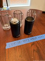 Front view showing two Yeti Colsters and three glass mugs