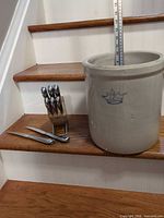 Group view of crock, knife block with 8 knives, carving knife and fork