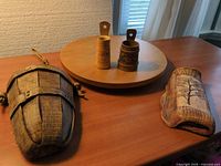 All four items on table: faux-wood basket, ceramic pocket, two wooden holders